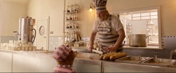Movie still from “Paddington 2” (2017), directed by Paul King – An old man and a small child in a kitchen; Medium shot, Over the shoulder angle