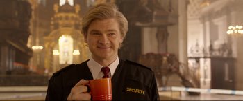 Movie still from “Paddington 2” (2017), directed by Paul King – A man holding a coffee mug in his hands; Medium shot, Over the shoulder angle