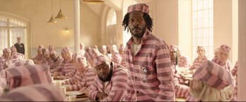 Movie still from “Paddington 2” (2017), directed by Paul King – A group of men in pink and white striped pajamas; Medium shot, Low angle
