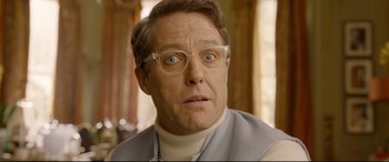 Movie still from “Paddington 2” (2017), directed by Paul King – A person wearing glasses and a sweater; Close Up shot, Low angle