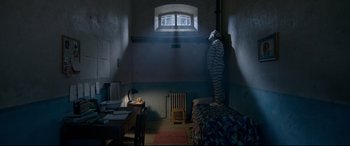 Movie still from “Paddington 2” (2017), directed by Paul King – A room with a bed , desk , chair , and a window; Wide shot, Low angle