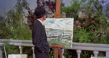 Movie still from “Pal Joey” (1957), directed by George Sidney – A man standing in front of an easel with a painting; Wide shot, Over the shoulder angle
