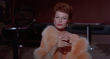 Movie still from “Pal Joey” (1957), directed by George Sidney – A woman in a fur coat holding a glass of wine; Close Up shot, Low angle