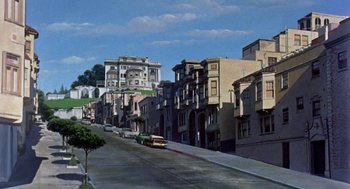 Movie still from “Pal Joey” (1957), directed by George Sidney – A street scene with a car parked on the side of the road; Extreme Wide shot, High angle