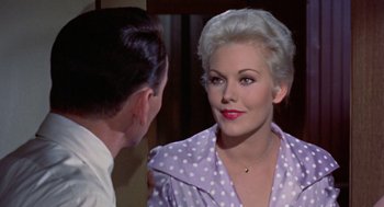 Movie still from “Pal Joey” (1957), directed by George Sidney – An older woman in a polka dot shirt looking at a younger man; Close Up shot, Over the shoulder angle