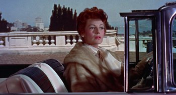 Movie still from “Pal Joey” (1957), directed by George Sidney – A woman sitting in the back seat of a car; Medium shot, Low angle