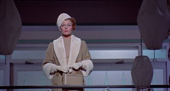 Movie still from “Pal Joey” (1957), directed by George Sidney – A woman wearing a hat , gloves , and a fur coat; Medium shot, Low angle
