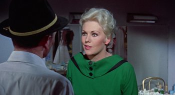 Movie still from “Pal Joey” (1957), directed by George Sidney – A woman in a green dress and a man in a black hat; Close Up shot, Over the shoulder angle