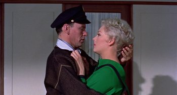 Movie still from “Pal Joey” (1957), directed by George Sidney – An older man and a younger woman in a room; Medium shot, High angle