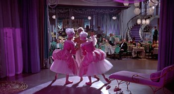 Movie still from “Pal Joey” (1957), directed by George Sidney – A group of women dressed in pink are dancing in a ballroom; Wide shot, Low angle