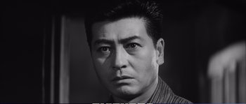 Black and white photograph of a man with a serious look