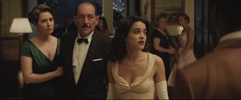 Movie still from “Palm Trees in the Snow” (2015), directed by Fernando González Molina – A man and a woman standing next to each other; Medium shot, Low angle