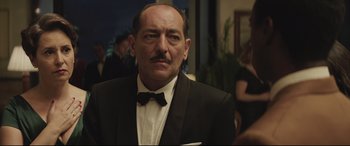 Movie still from “Palm Trees in the Snow” (2015), directed by Fernando González Molina – A man in a suit and a bow tie; Close Up shot, Low angle