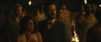 Movie still from “Palm Trees in the Snow” (2015), directed by Fernando González Molina – A group of people standing in a room; Medium shot, Over the shoulder angle