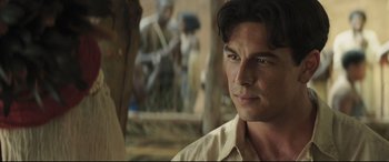 Movie still from “Palm Trees in the Snow” (2015), directed by Fernando González Molina – A person wearing a white shirt; Close Up shot, Over the shoulder angle