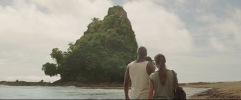 Movie still from “Palm Trees in the Snow” (2015), directed by Fernando González Molina – A man and a woman looking out at a mountain; Extreme Wide shot, Low angle
