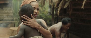 Movie still from “Palm Trees in the Snow” (2015), directed by Fernando González Molina – A woman holding a man's arm in front of a mirror; Close Up shot, Over the shoulder angle
