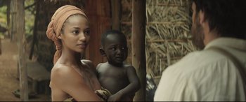 Movie still from “Palm Trees in the Snow” (2015), directed by Fernando González Molina – A woman and a child are standing together; Medium shot, Over the shoulder angle