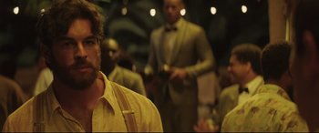 Movie still from “Palm Trees in the Snow” (2015), directed by Fernando González Molina – A group of men in suits and ties standing in a room; Close Up shot, Over the shoulder angle