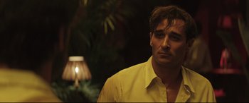 Movie still from “Palm Trees in the Snow” (2015), directed by Fernando González Molina – A person wearing a yellow shirt; Close Up shot, Over the shoulder angle