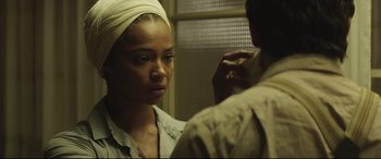 Movie still from “Palm Trees in the Snow” (2015), directed by Fernando González Molina – A woman with a head scarf looking in the mirror; Close Up shot, Over the shoulder angle