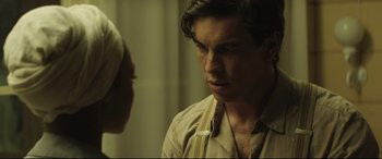 Movie still from “Palm Trees in the Snow” (2015), directed by Fernando González Molina – A man in a tan shirt is looking at a woman in a white dress; Close Up shot, Over the shoulder angle
