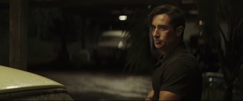 Movie still from “Palm Trees in the Snow” (2015), directed by Fernando González Molina – A person wearing a black shirt; Medium shot, Over the shoulder angle