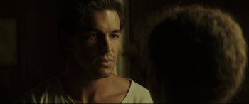 Movie still from “Palm Trees in the Snow” (2015), directed by Fernando González Molina – A person wearing a white t - shirt; Close Up shot, Over the shoulder angle