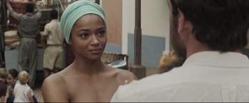 Movie still from “Palm Trees in the Snow” (2015), directed by Fernando González Molina – A woman with a green head scarf looking into a mirror; Close Up shot, Over the shoulder angle