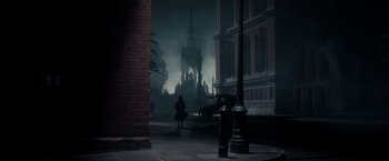 Movie still from “Pan” (2015), directed by Joe Wright – A woman is walking down the street in the dark; Extreme Wide shot, Low angle