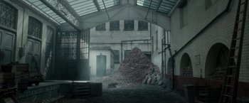 Movie still from “Pan” (2015), directed by Joe Wright – A large pile of garbage in a large room; Extreme Wide shot, High angle