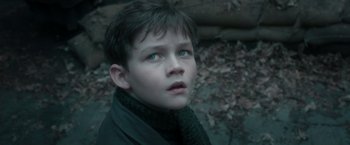Movie still from “Pan” (2015), directed by Joe Wright – A young boy wearing a black jacket and a black scarf; Close Up shot, Over the shoulder angle