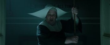 Movie still from “Pan” (2015), directed by Joe Wright – A woman wearing a nun's hat and holding a stick; Close Up shot, Low angle