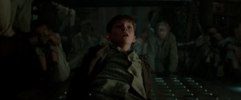 Movie still from “Pan” (2015), directed by Joe Wright – A young boy is looking up at the sky; Medium shot, Low angle