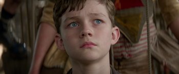 Movie still from “Pan” (2015), directed by Joe Wright – A young boy with blue eyes; Close Up shot, Low angle
