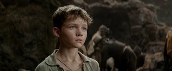 Movie still from “Pan” (2015), directed by Joe Wright – A young boy with blue eyes stares into the distance; Close Up shot, Low angle