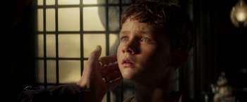 Movie still from “Pan” (2015), directed by Joe Wright – A young boy is looking up at the sky; Close Up shot, Over the shoulder angle