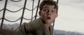 Movie still from “Pan” (2015), directed by Joe Wright – A young boy is looking up at the sky; Close Up shot, Low angle