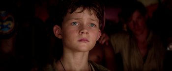 Movie still from “Pan” (2015), directed by Joe Wright – A young boy with blue eyes stares into the distance; Close Up shot, High angle