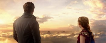 Movie still from “Pan” (2015), directed by Joe Wright – A man standing on a hill looking out at the sky; Medium shot, Over the shoulder angle