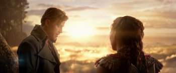 Movie still from “Pan” (2015), directed by Joe Wright – Two women are standing in front of a sunset; Close Up shot, Over the shoulder angle