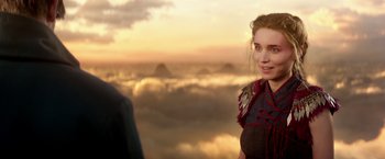 Movie still from “Pan” (2015), directed by Joe Wright – A young woman standing in front of a sky filled with clouds; Close Up shot, Over the shoulder angle