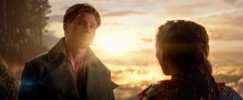 Movie still from “Pan” (2015), directed by Joe Wright – A man and a woman standing next to each other in front of a sunset; Close Up shot, Over the shoulder angle