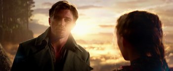 Movie still from “Pan” (2015), directed by Joe Wright – A man and a woman standing next to each other in front of a sunset; Close Up shot, Over the shoulder angle