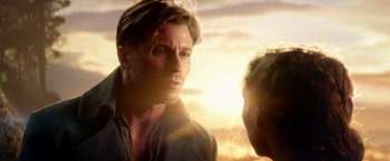 Movie still from “Pan” (2015), directed by Joe Wright – A man standing next to another man on a beach; Close Up shot, Over the shoulder angle