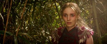 Movie still from “Pan” (2015), directed by Joe Wright – A young woman with green eyes standing next to a tree; Close Up shot, Over the shoulder angle