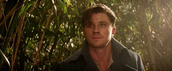 Movie still from “Pan” (2015), directed by Joe Wright – A person wearing a jacket near a tree; Close Up shot, Low angle