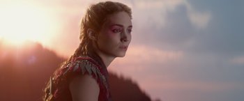 Movie still from “Pan” (2015), directed by Joe Wright – A young woman with pink eye shadow is looking into the distance; Close Up shot, Over the shoulder angle