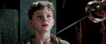 Movie still from “Pan” (2015), directed by Joe Wright – A young boy is looking up at the sky; Close Up shot, High angle