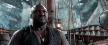 Movie still from “Pan” (2015), directed by Joe Wright – A man with a beard is looking at the camera; Close Up shot, Low angle